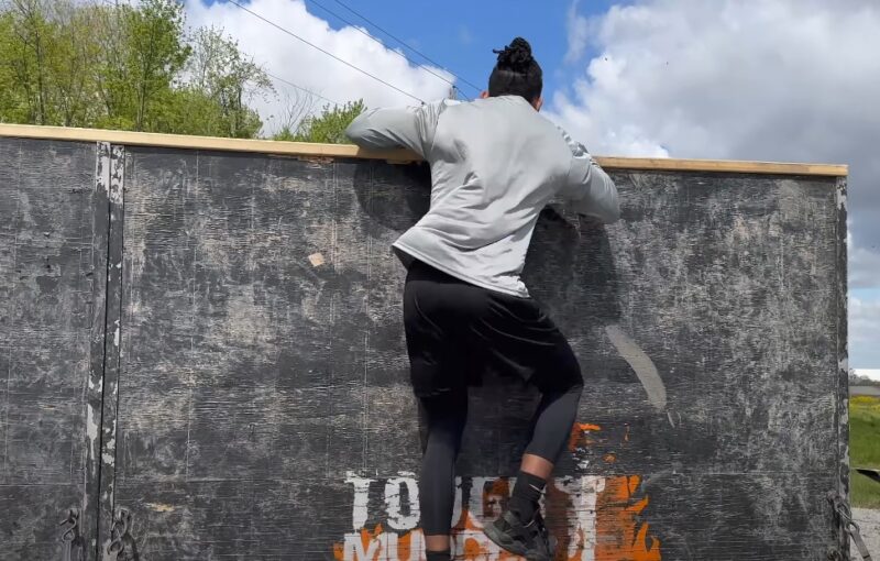 Person jumping over obstacle in Tough Mudder